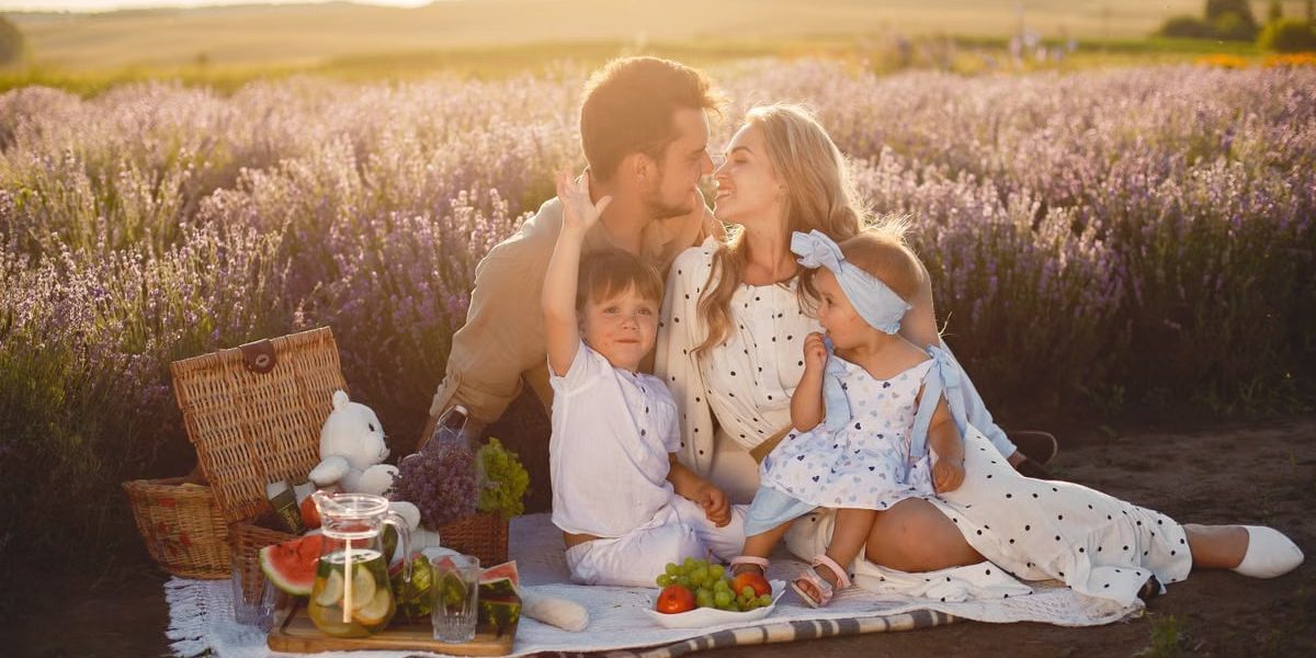 A joyful family picnic in a lavender field, capturing togetherness and love at sunset.