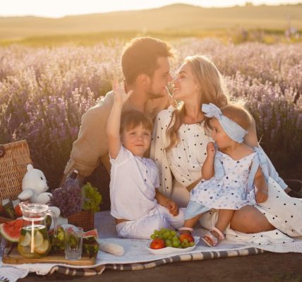 A joyful family picnic in a lavender field, capturing togetherness and love at sunset.