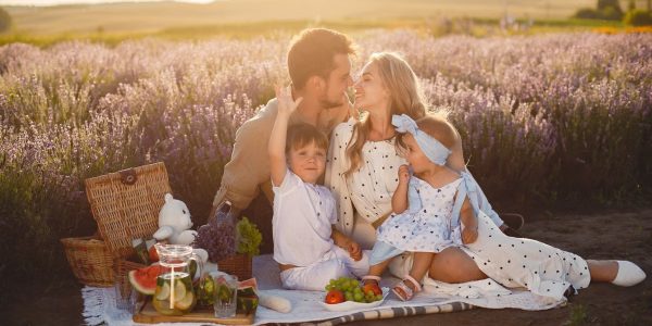 A joyful family picnic in a lavender field, capturing togetherness and love at sunset.