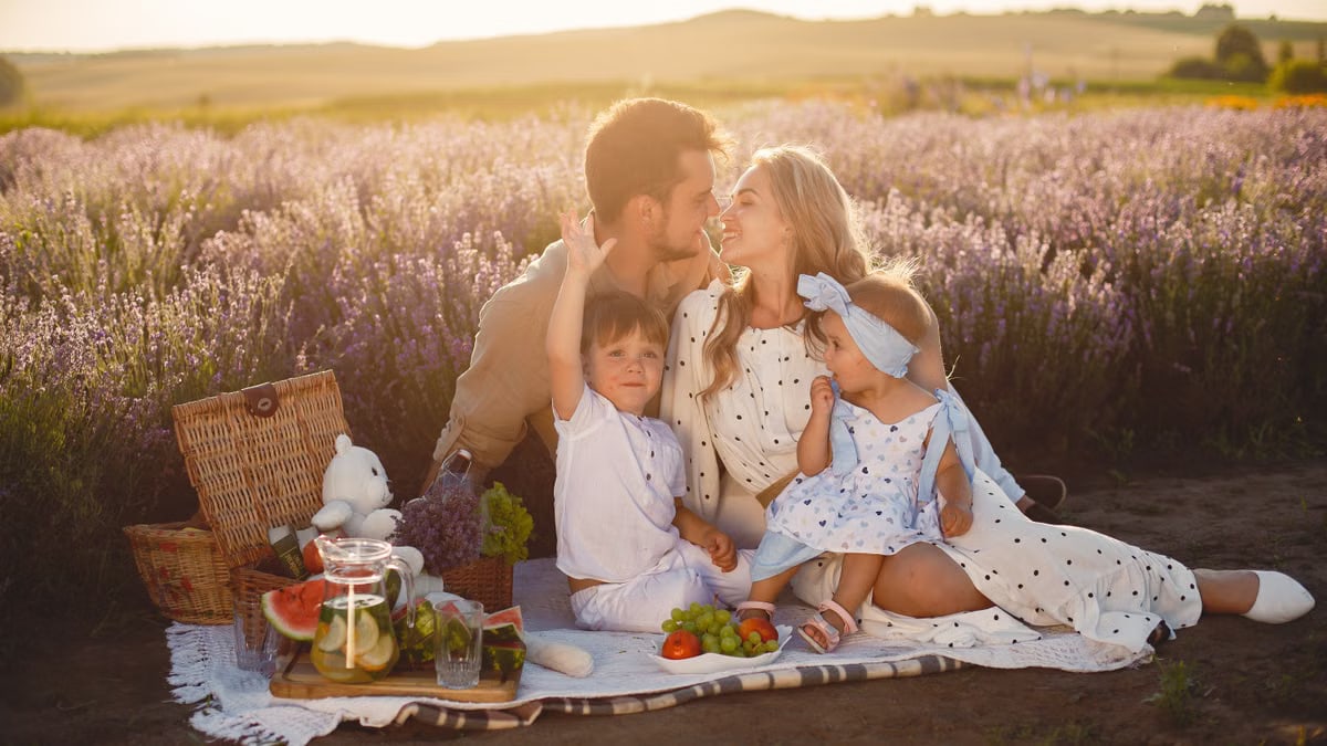 A joyful family picnic in a lavender field, capturing togetherness and love at sunset.